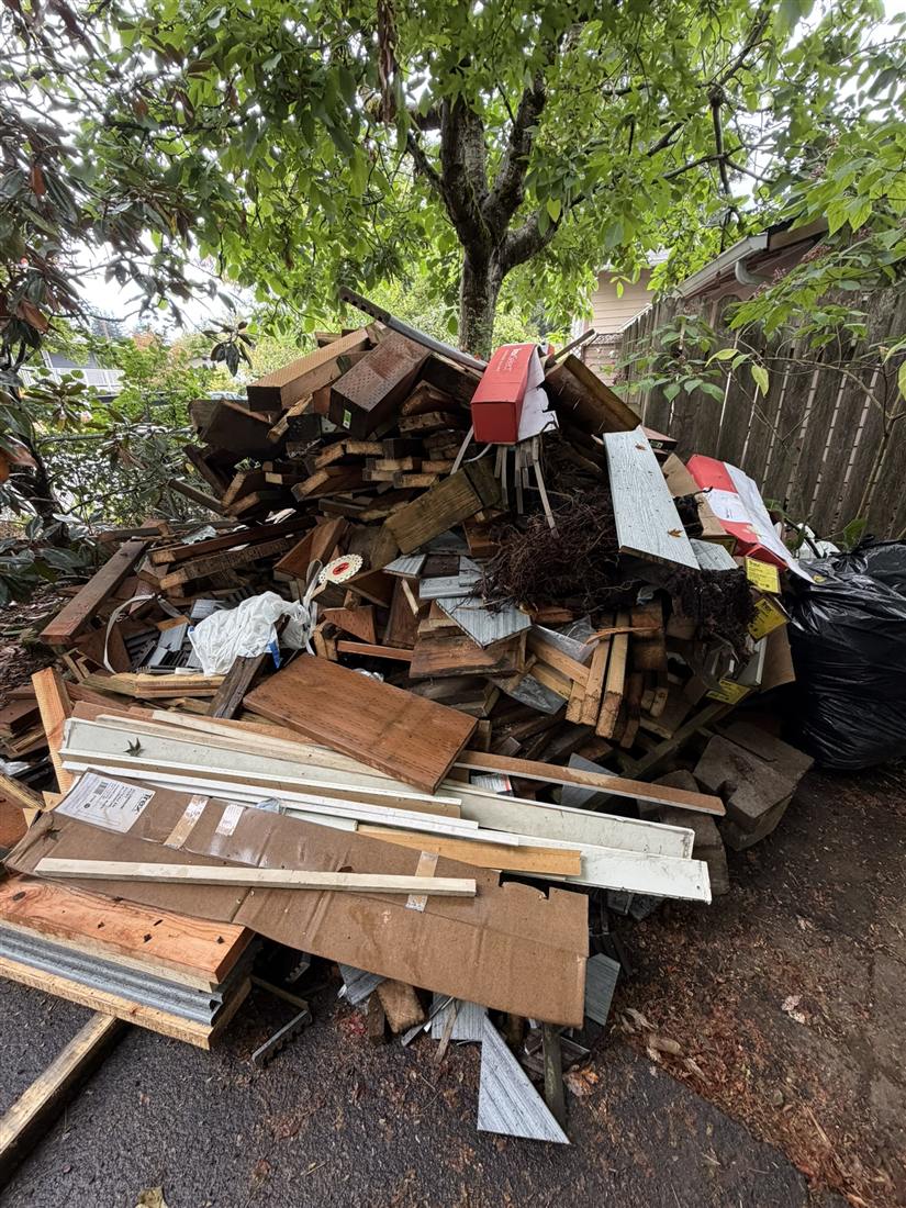Before - deck demolition debris pile stacked by the contractor