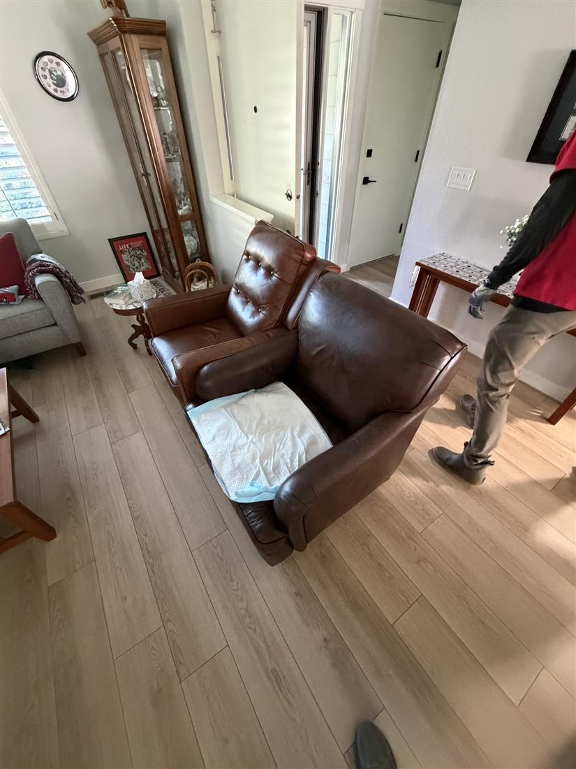 Crew carrying a recliner out during an estate cleanout