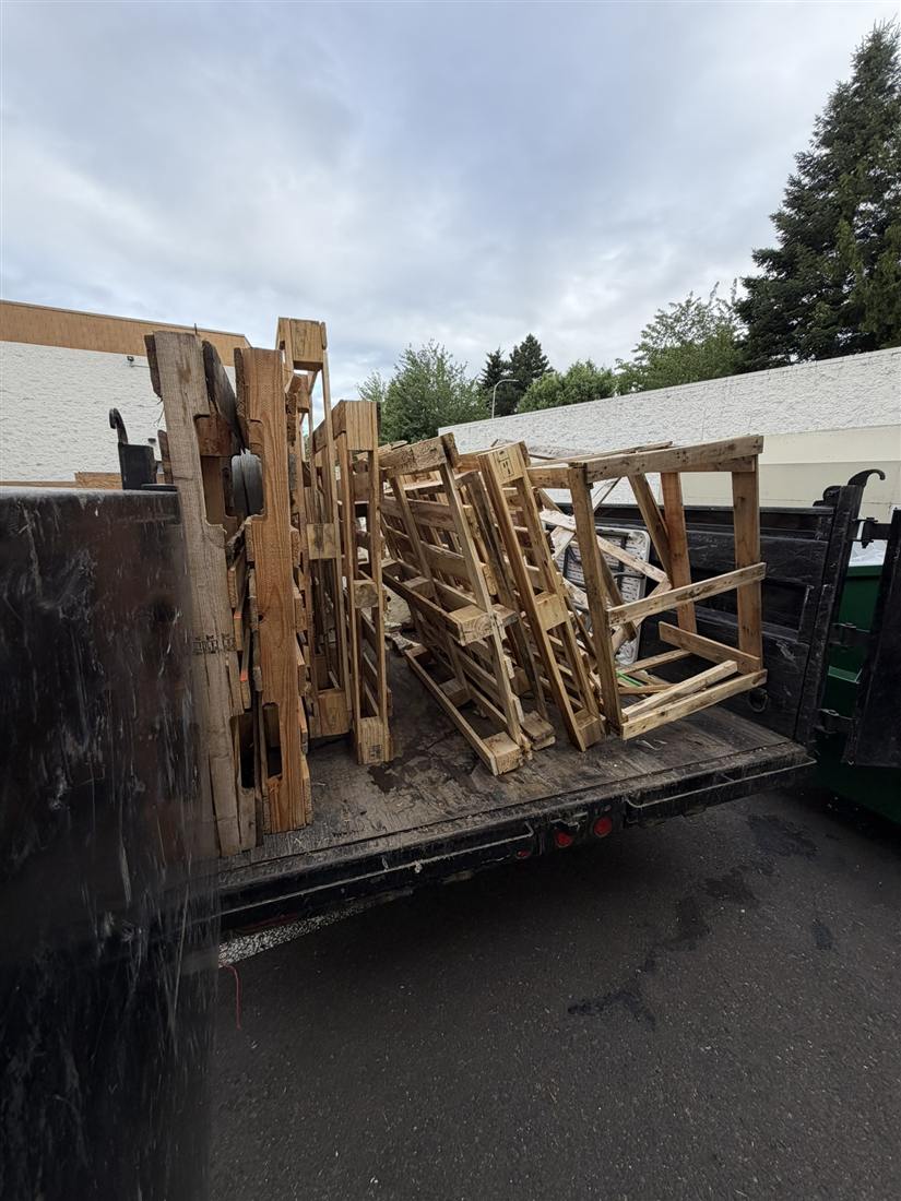 Flatbed trailer loaded for heavy equipment and pallet hauling