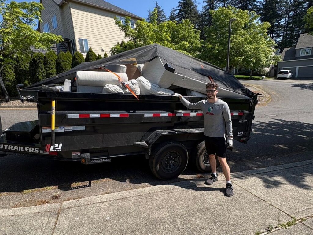 All Oregon Junk Removal dump trailer loaded with a full junk load, tarped and ready to haul